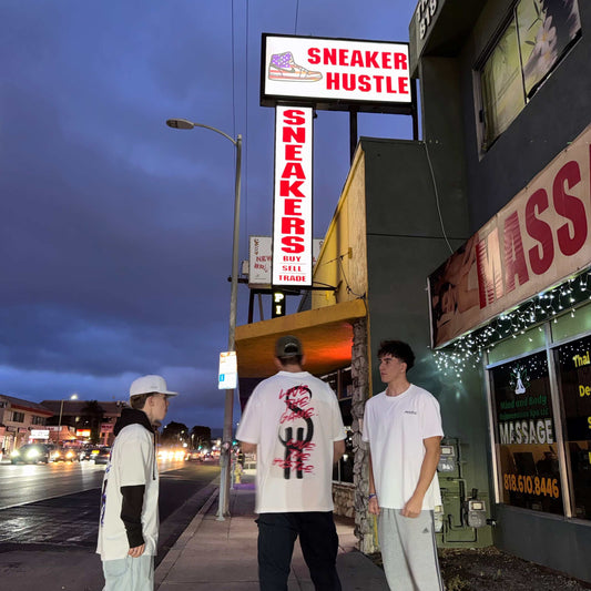 Sneaker Hustle shop exterior in Los Angeles with young people outside at dusk showcasing sneaker culture and releases in Los Angeles