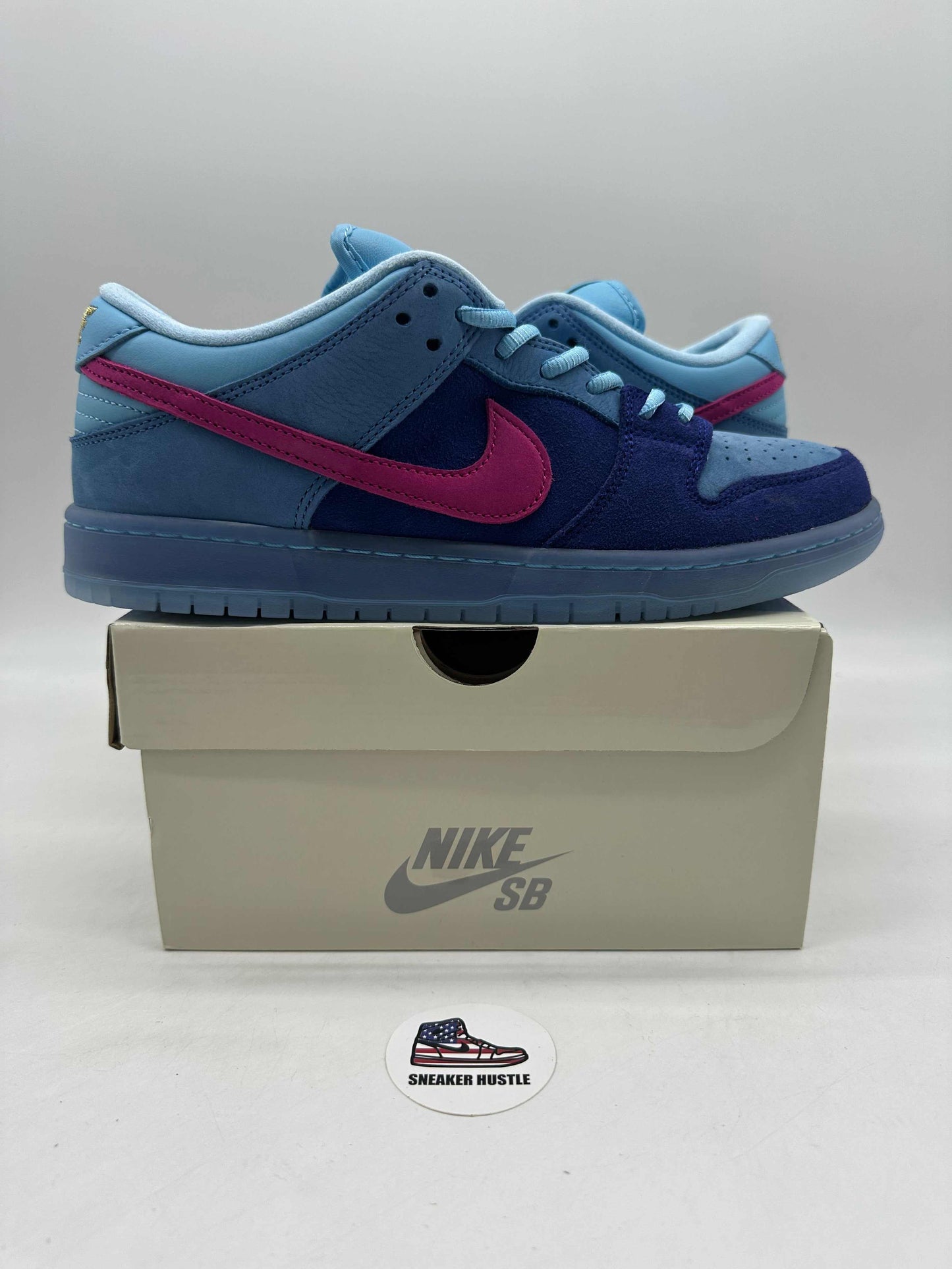 Nike SB Dunk Low Run The Jewels sneaker in blue and pink on a Nike SB shoebox