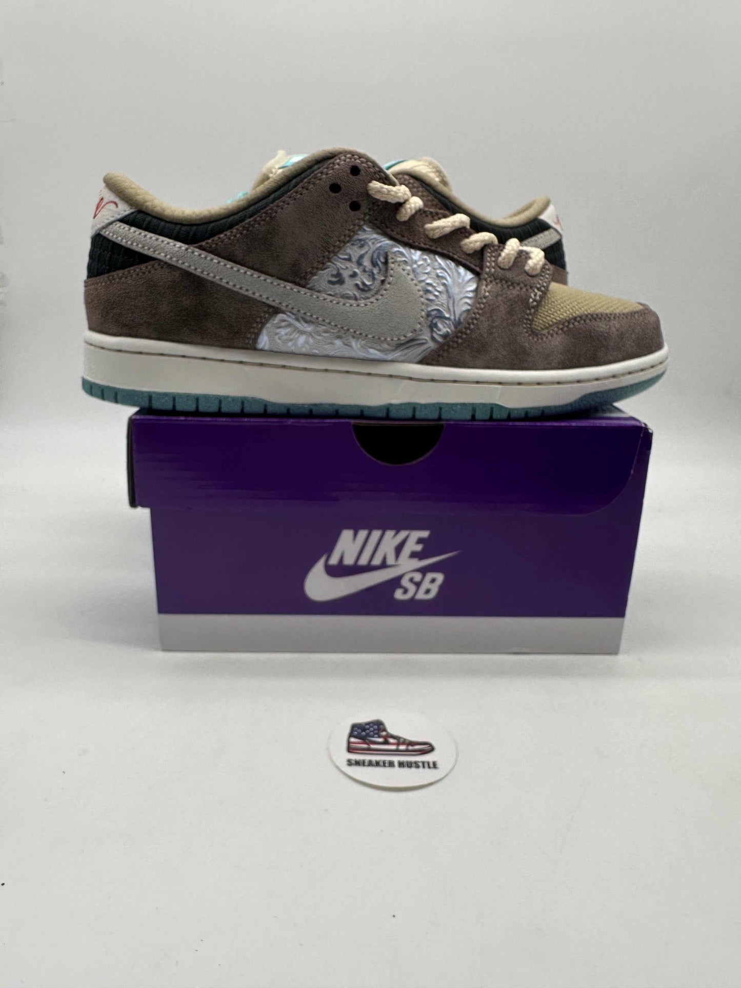 Nike SB Dunk Low Big Money Savings sneaker in brown and gray suede on a purple Nike SB box