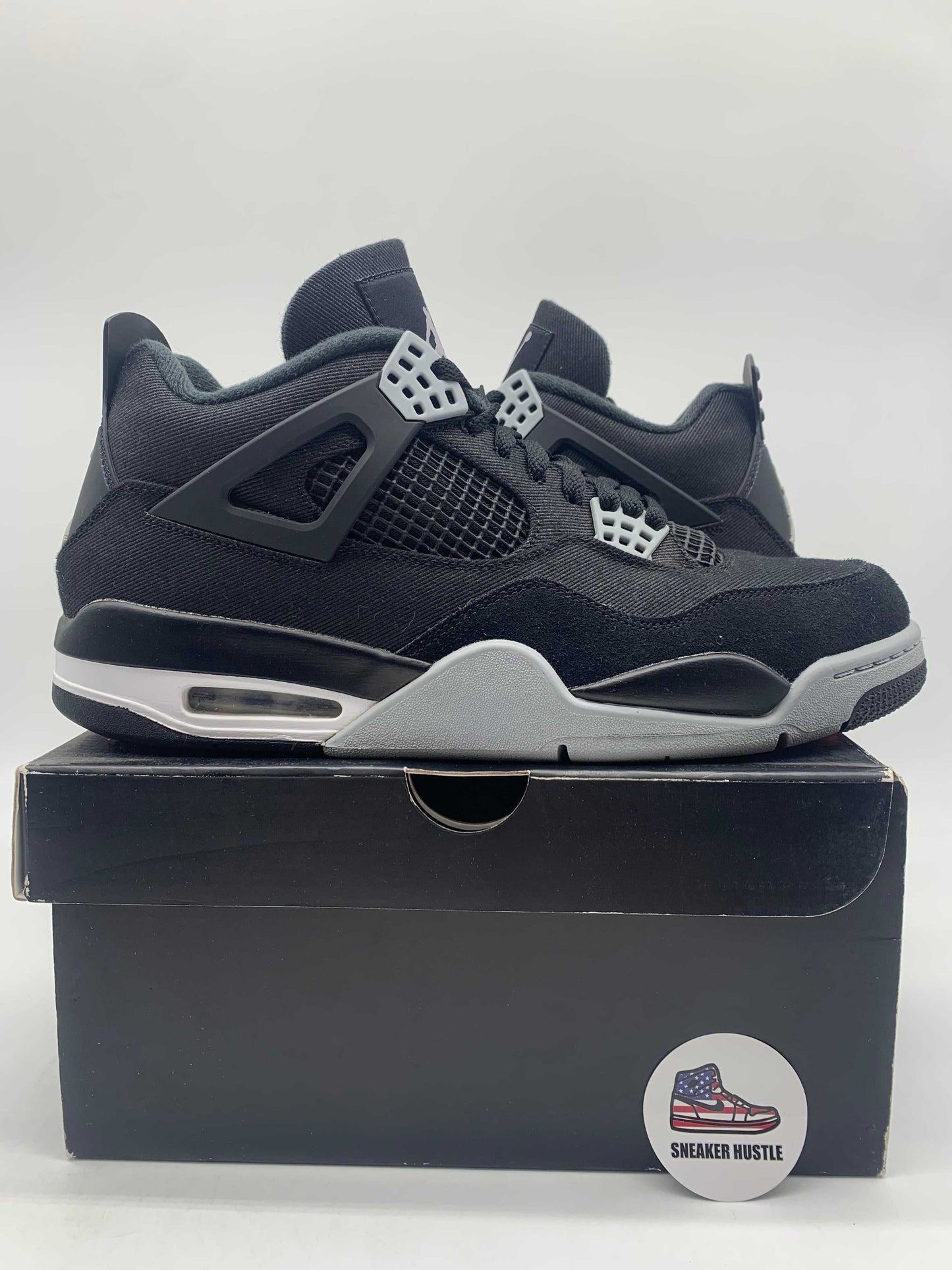 Jordan 4 Retro SE Black Canvas sneakers size 12 preowned displayed on box with damaged label