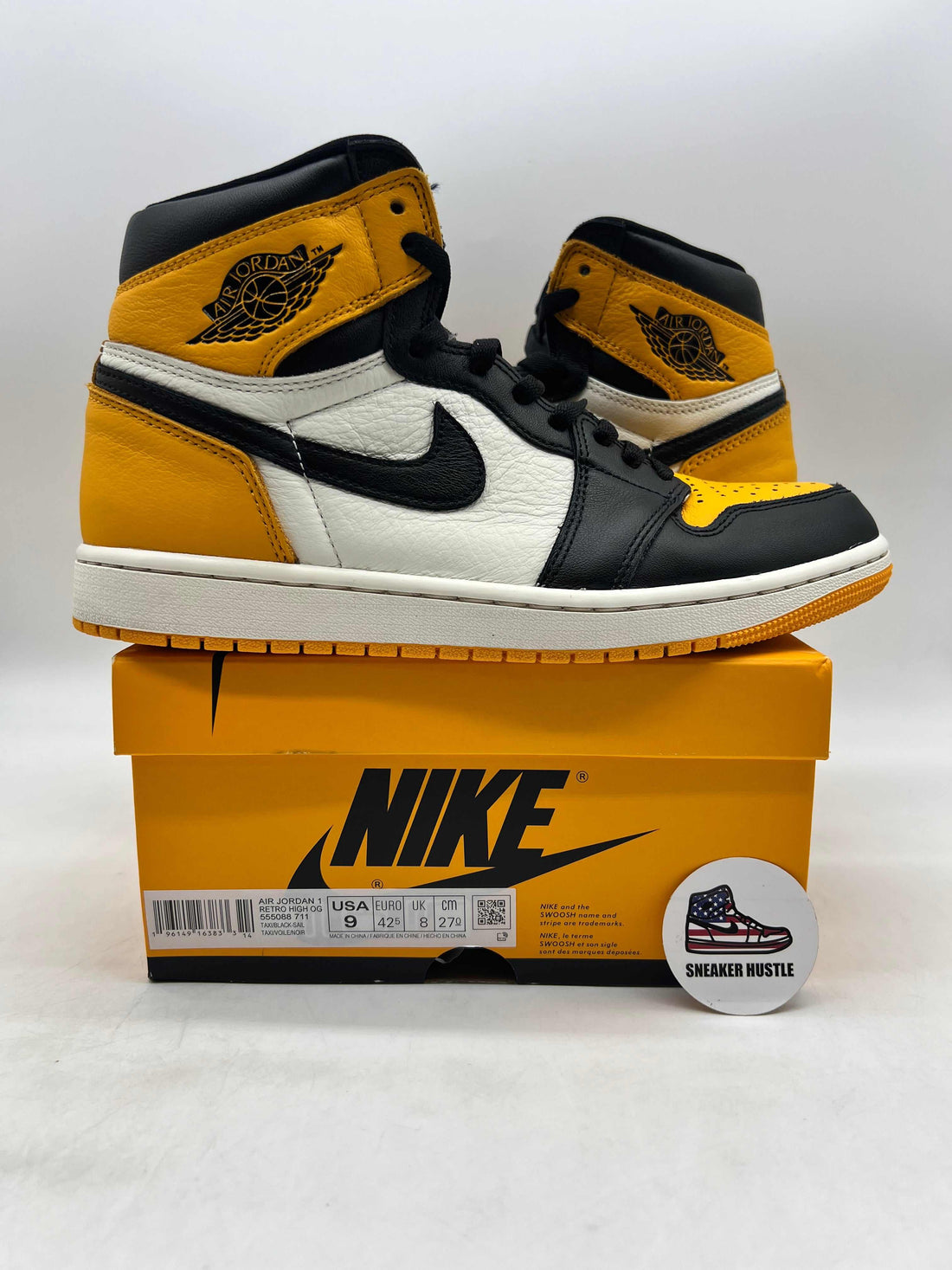 Pair of Air Jordan 1 Retro High OG "Taxi" sneakers on Nike orange box, Holiday Jordans 2025 in Los Angeles guide focus.