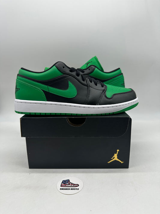 Green and black Jordan 1 Low Lucky Green sneakers on black Jordan shoebox