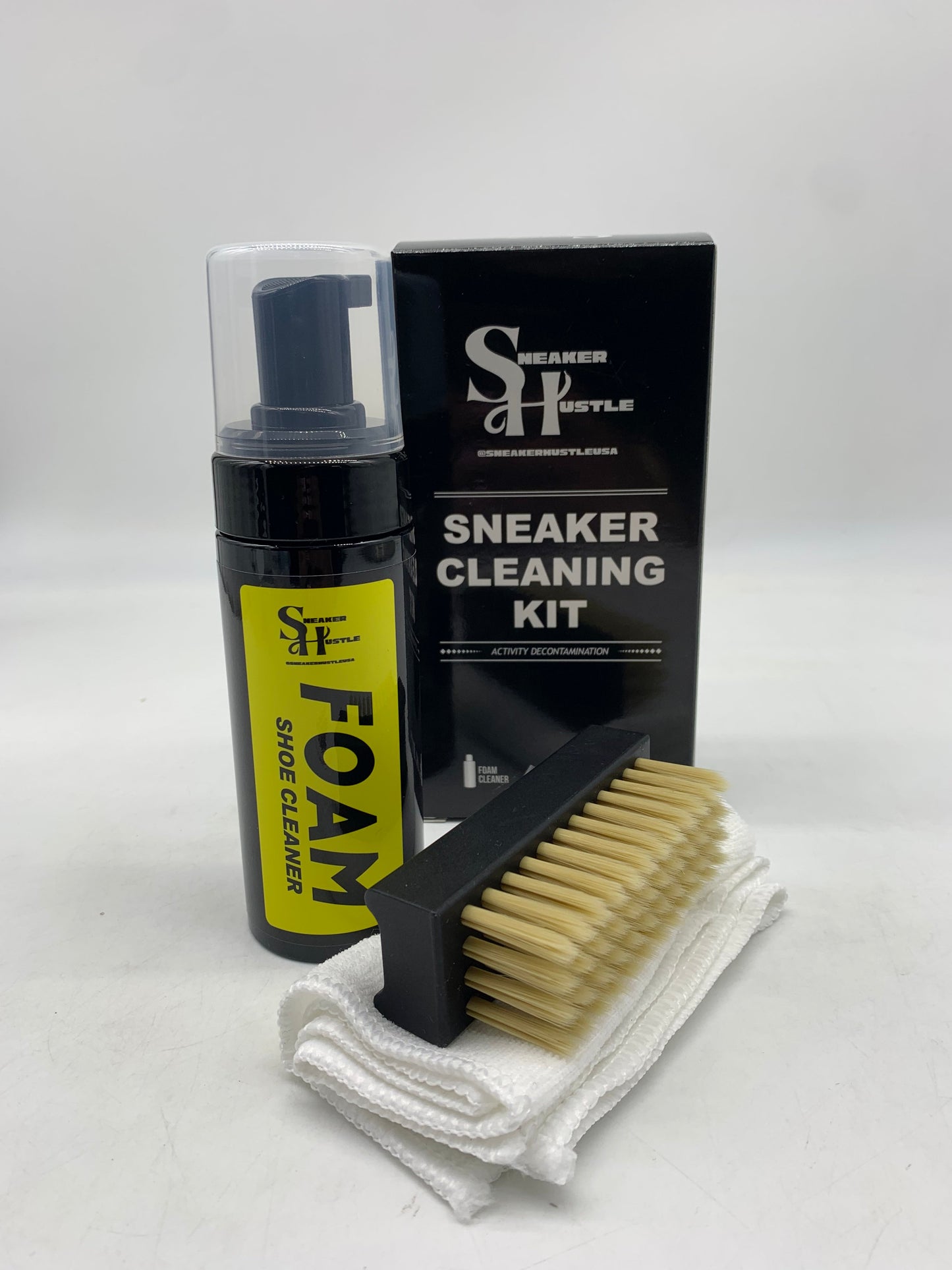 Sneaker Hustle shoe cleaner kit with foam soap, brush, and towel for sneaker cleaning.