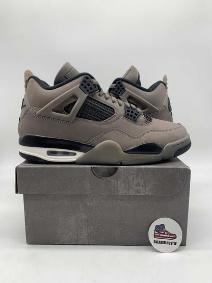 Jordan 4 Retro Cave Stone sneakers in gray and black colorway on a box with Sneaker Hustle badge