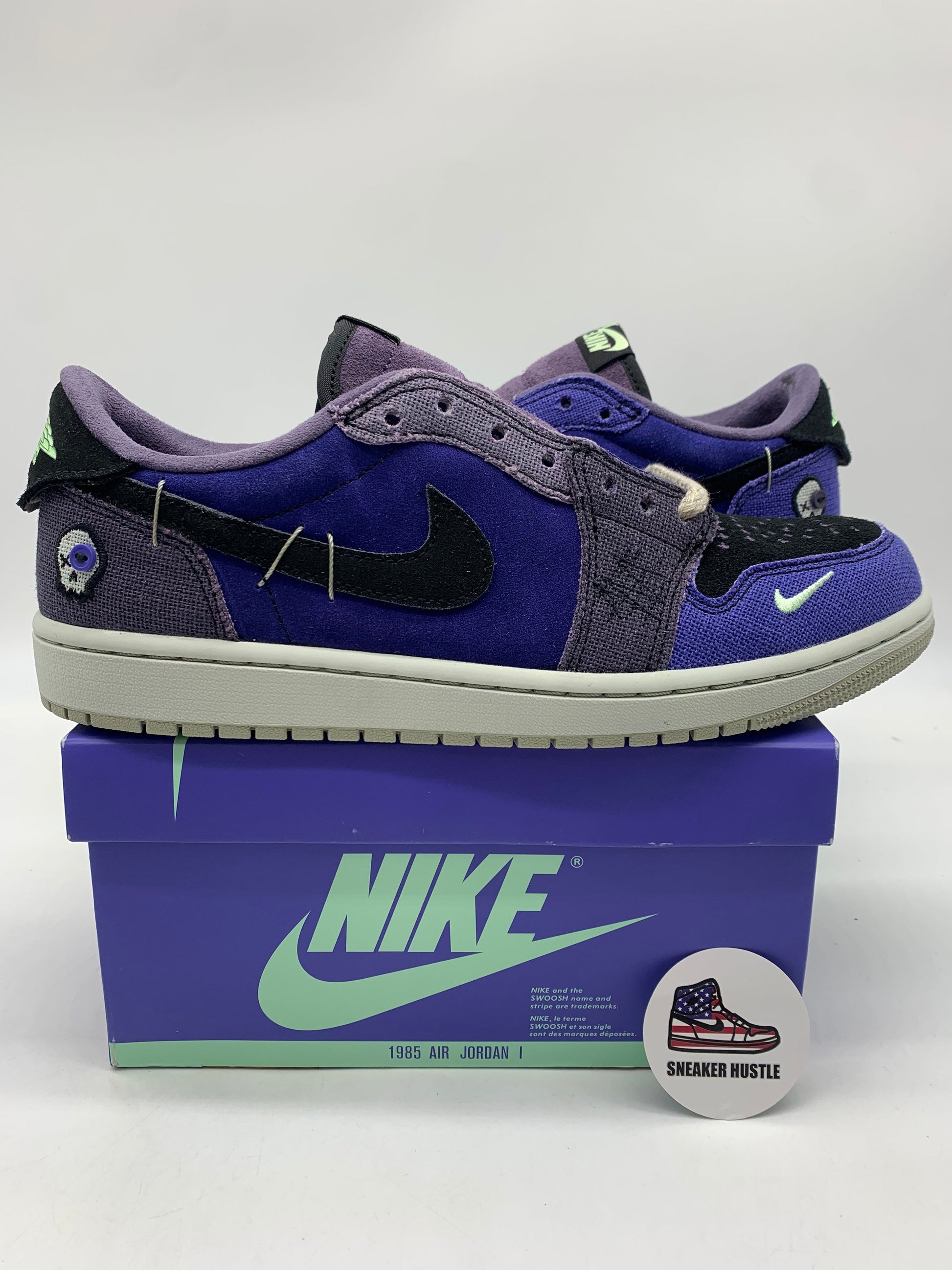 Jordan 1 Retro Low OG Zion Williamson Voodoo Alternate sneakers in purple and black on Nike box