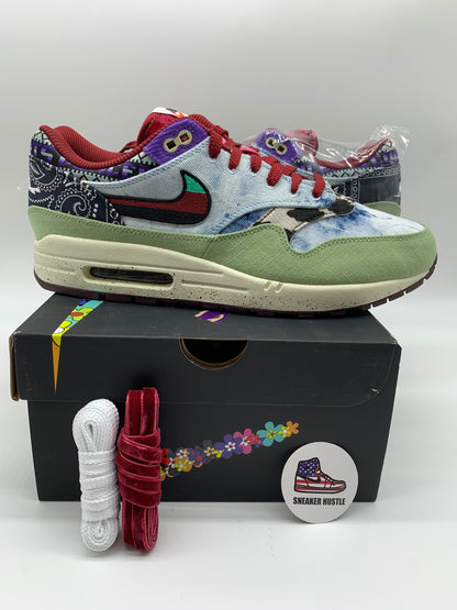 Nike Air Max 1 SP Concepts Mellow sneaker in multicolor with green suede, red laces, and paisley pattern design on black box with extra laces and pin badge